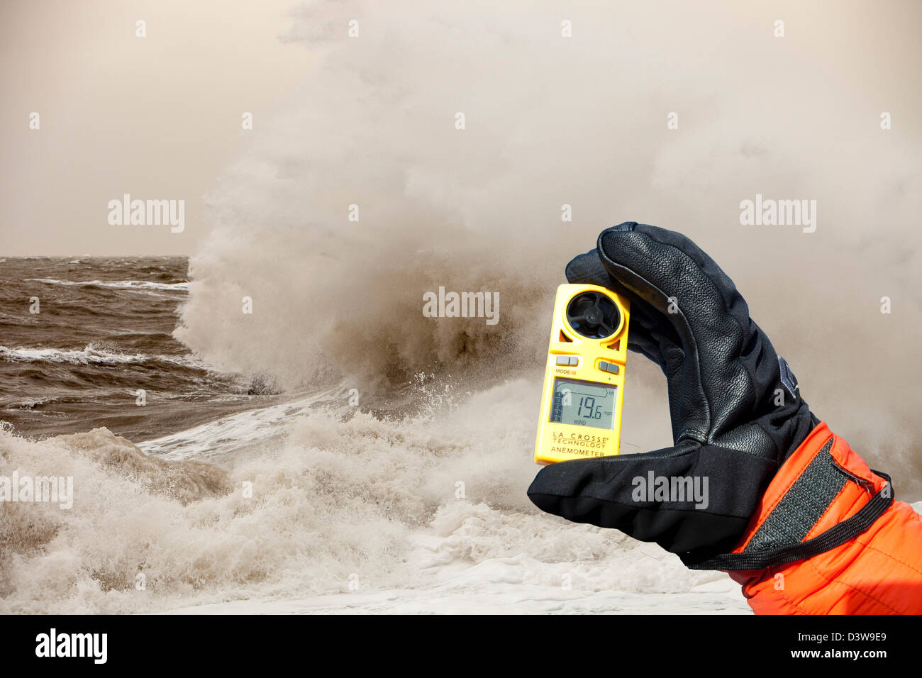 Gale force winds and crashing waves battering the coastal defences in Harrington, Workington, Cumbria, UK, with an anemometer Stock Photo