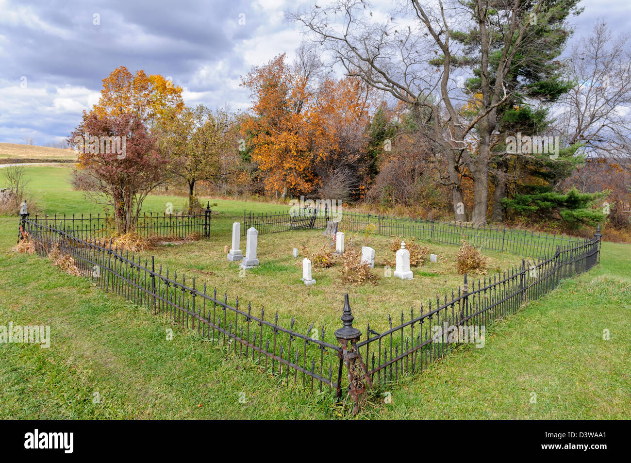 Small rural cemetery in the fall with Victorian iron fence around it, Pennsylvania, PA, USA. Stock Photo