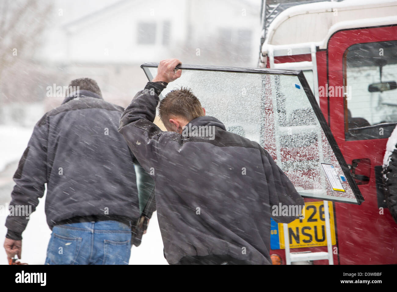A glazier carries a double glazed unit up Fisherbeck Park in Ambleside