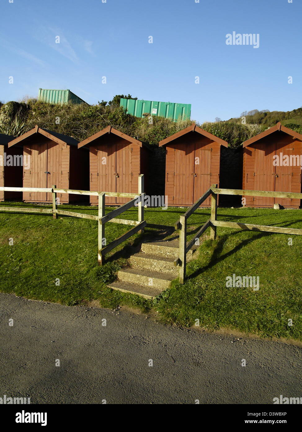 A row of red beach huts on Branscombe beach Stock Photo