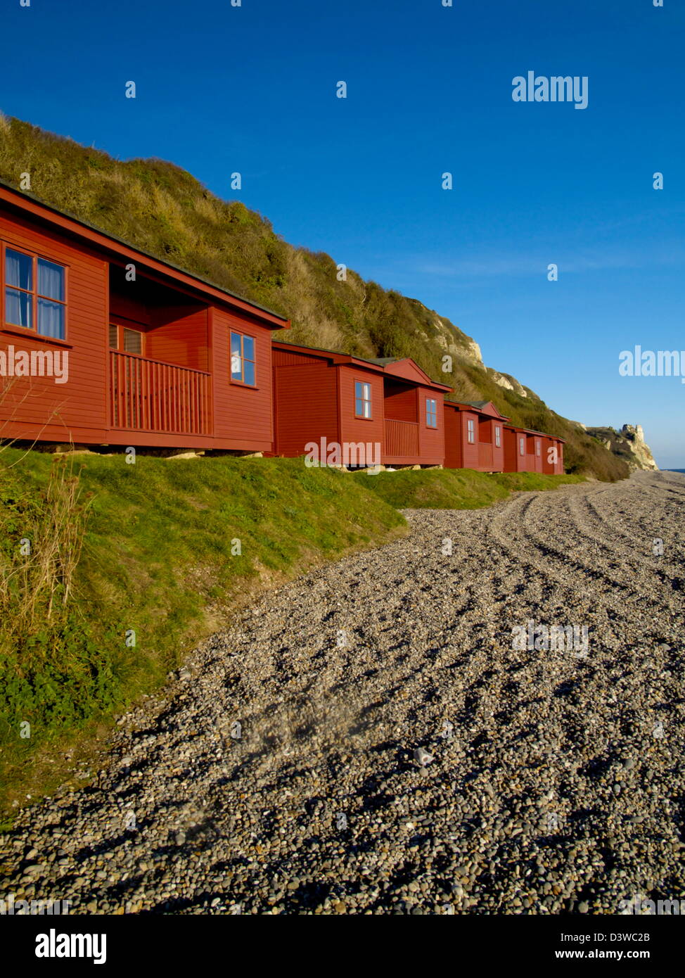 A row of red beach huts on Branscombe beach Stock Photo