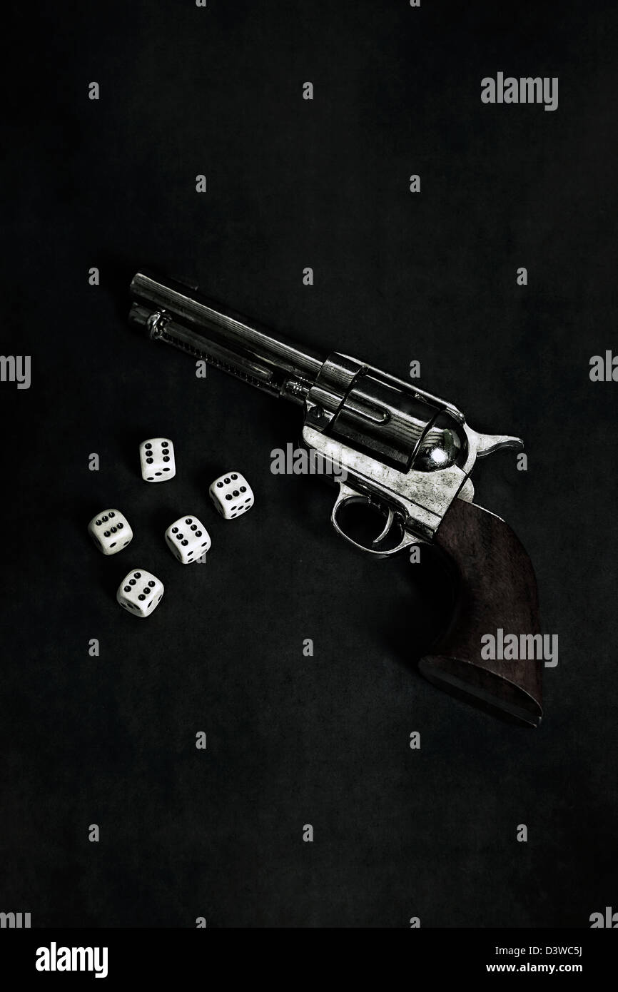 a gun with five dice Stock Photo