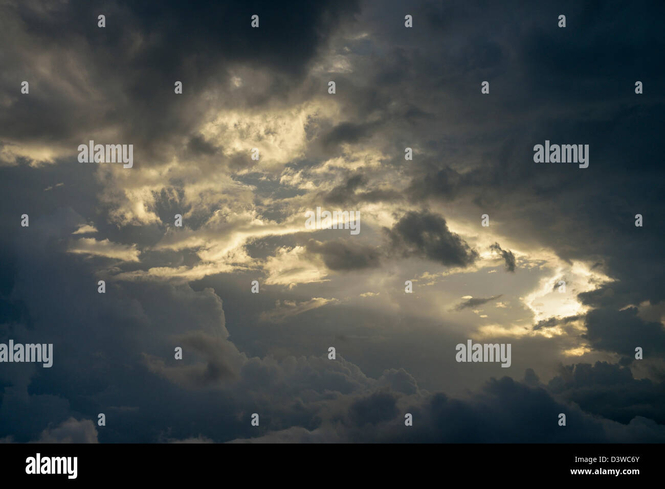 Sun rays through stormy dramatic sky Stock Photo