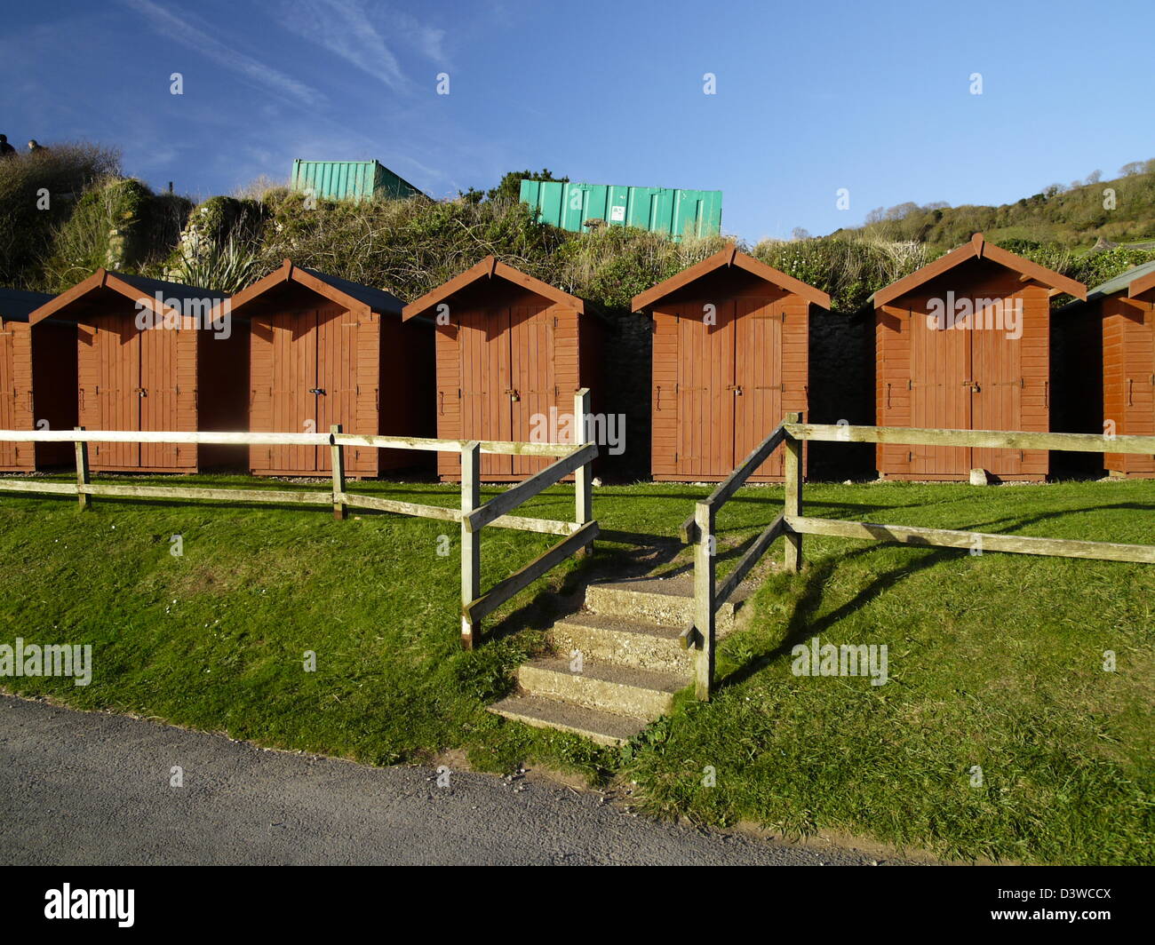A row of red beach huts on Branscombe beach Stock Photo