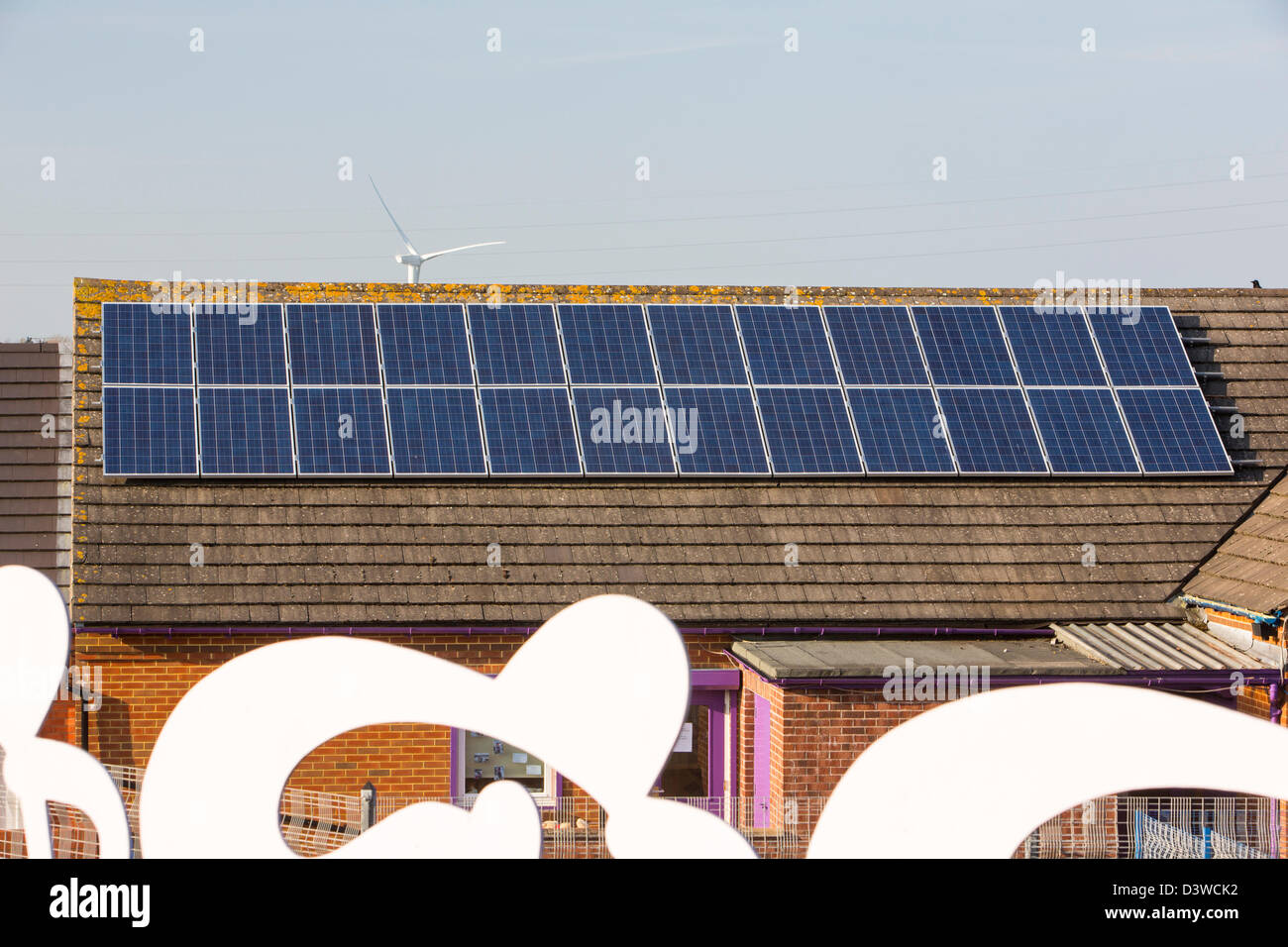 A nursery school in Seaton near Workington, Cumbria UK, with solar panels on the roof, and a Sustrans cycle route Stock Photo