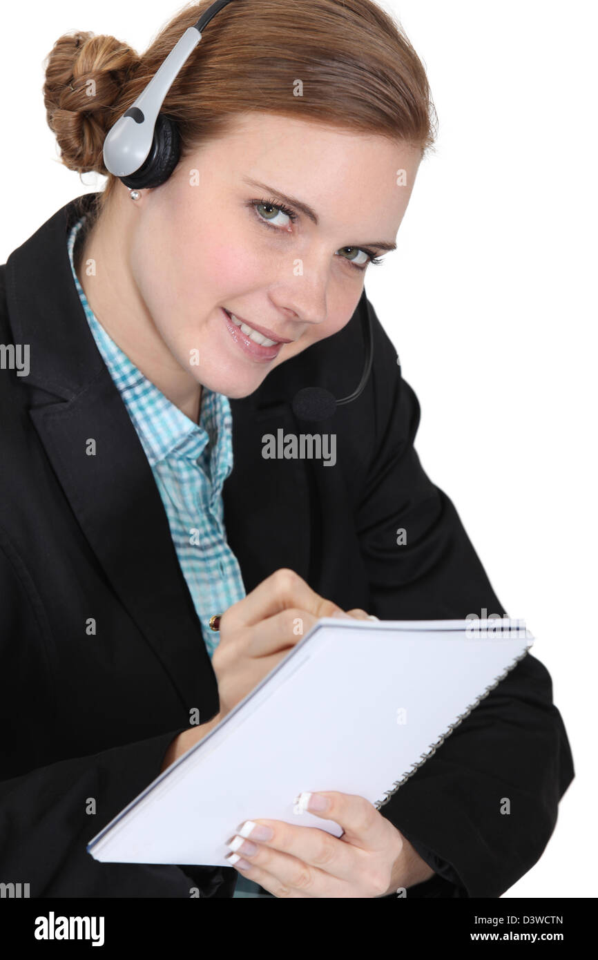 Receptionist writing in a notebook Stock Photo - Alamy