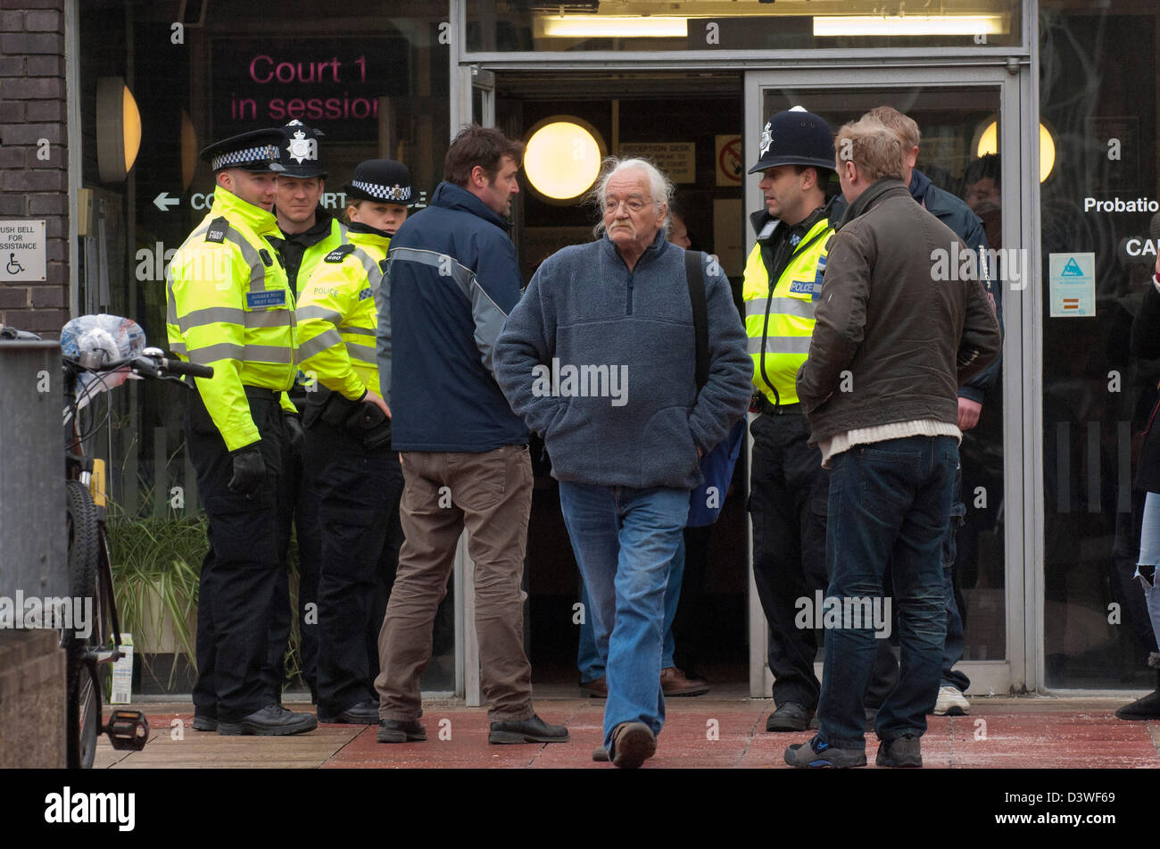 25th February, 2013. Horsham UK. A supporter is ejected from the court. 9/11 truth documentary maker Tony Rooke is granted a Magistrates Court hearing after making a stand by refusing to pay his TV licence fee and challenging the BBC's support of terrorist activity through supporting the cover up of true evidence of 9/11. The BBC is being challenged strongly for its refusal to present to the British public the available scientific evidence which contradicts the official version of events of 11th September 2001. Photo Credit: Graham M. Lawrence/Alamy Live News. Stock Photo