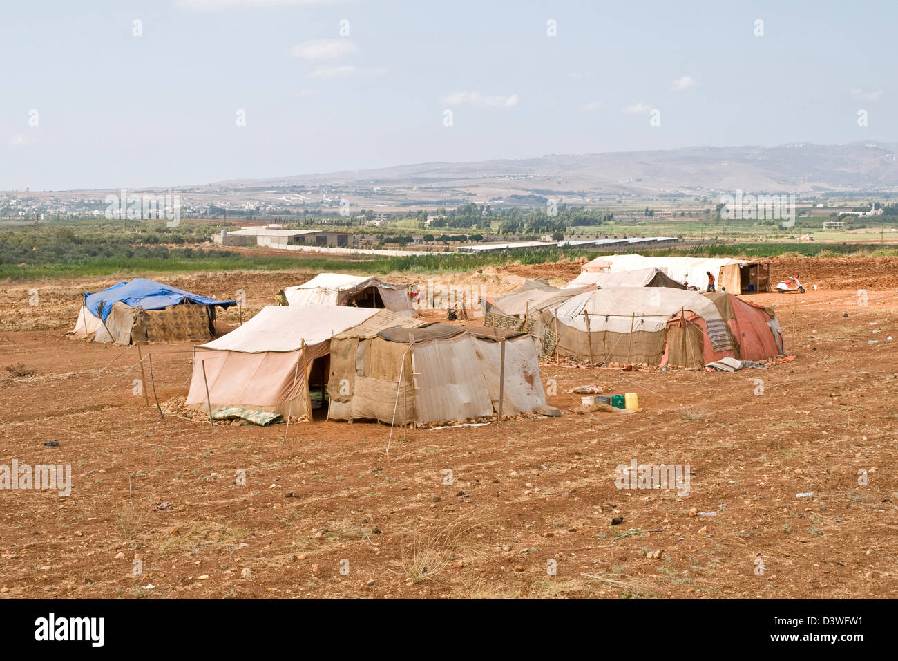 A tent refugee camp for Syrian migrants on a farm in the northern Lebanese region of Wadi Khaled, just south of the Syria-Lebanon border. Stock Photo