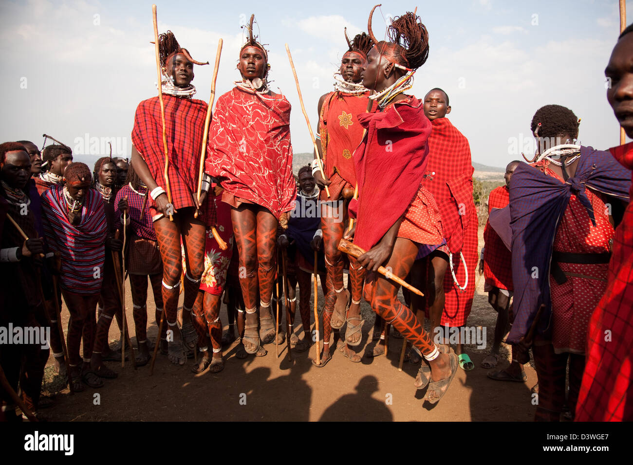 Young men called Morans are competing in jumping as high and straight as possible, a competitive dance called adumu, at a party. Stock Photo
