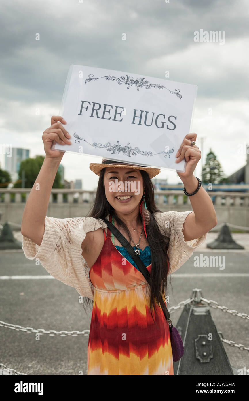 Woman offering free hugs at the entrance of Yoyogi Park, Tokyo, Japan, Asia Stock Photo