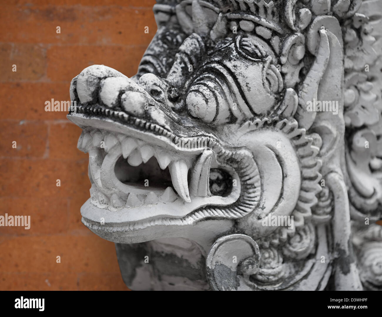 Image of mythical personage Barong from Balinese epos with orange wall on background Stock Photo