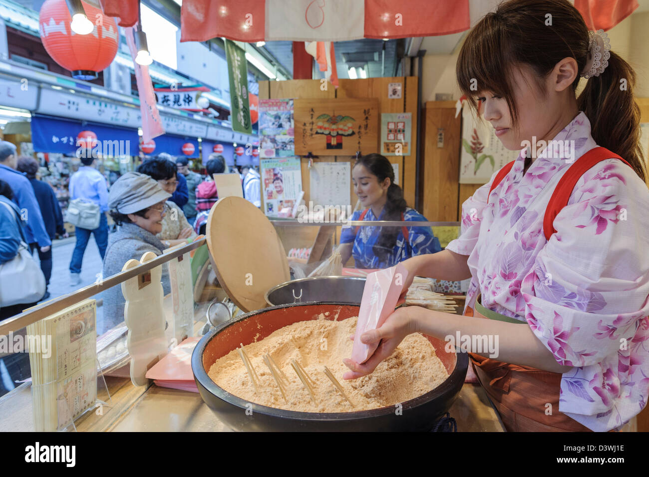 Woman selling sweets in a food stall on the streets of Tokyo, Japan, Asia Stock Photo