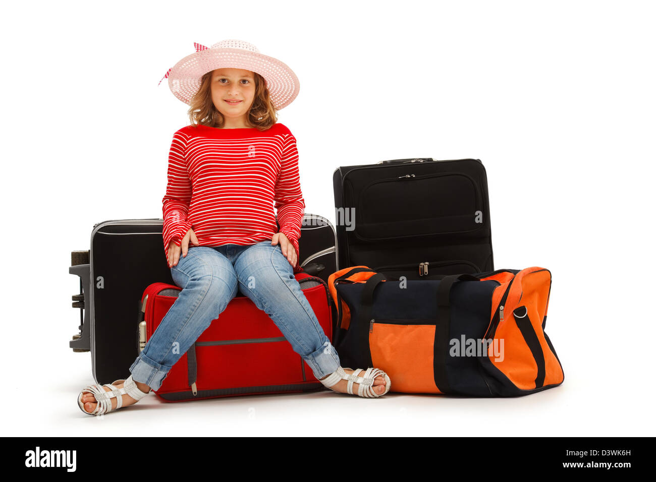 Young girl sitting on luggages and waiting. Isolated on white Stock Photo