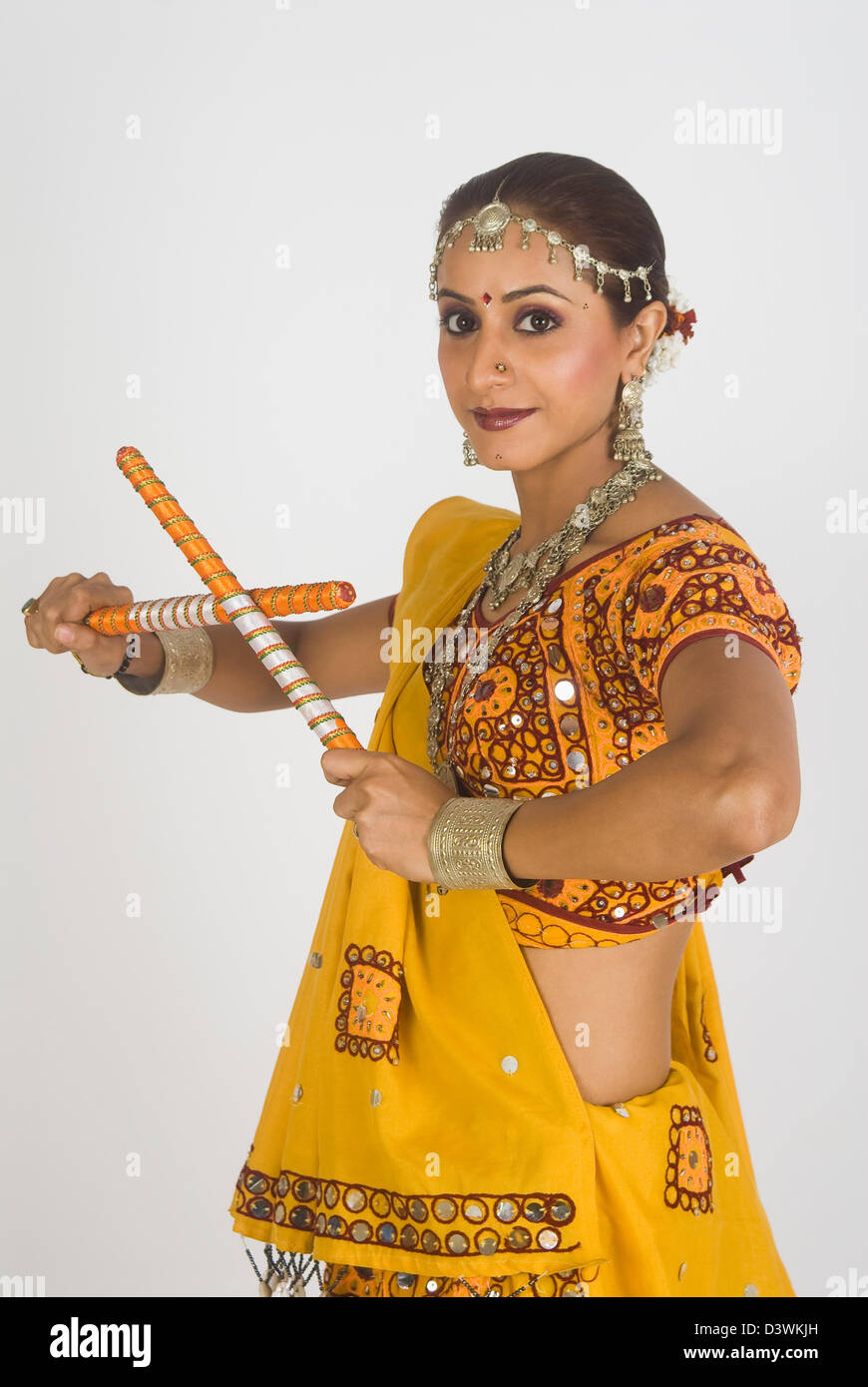 Portrait of a woman performing dandiya Stock Photo - Alamy