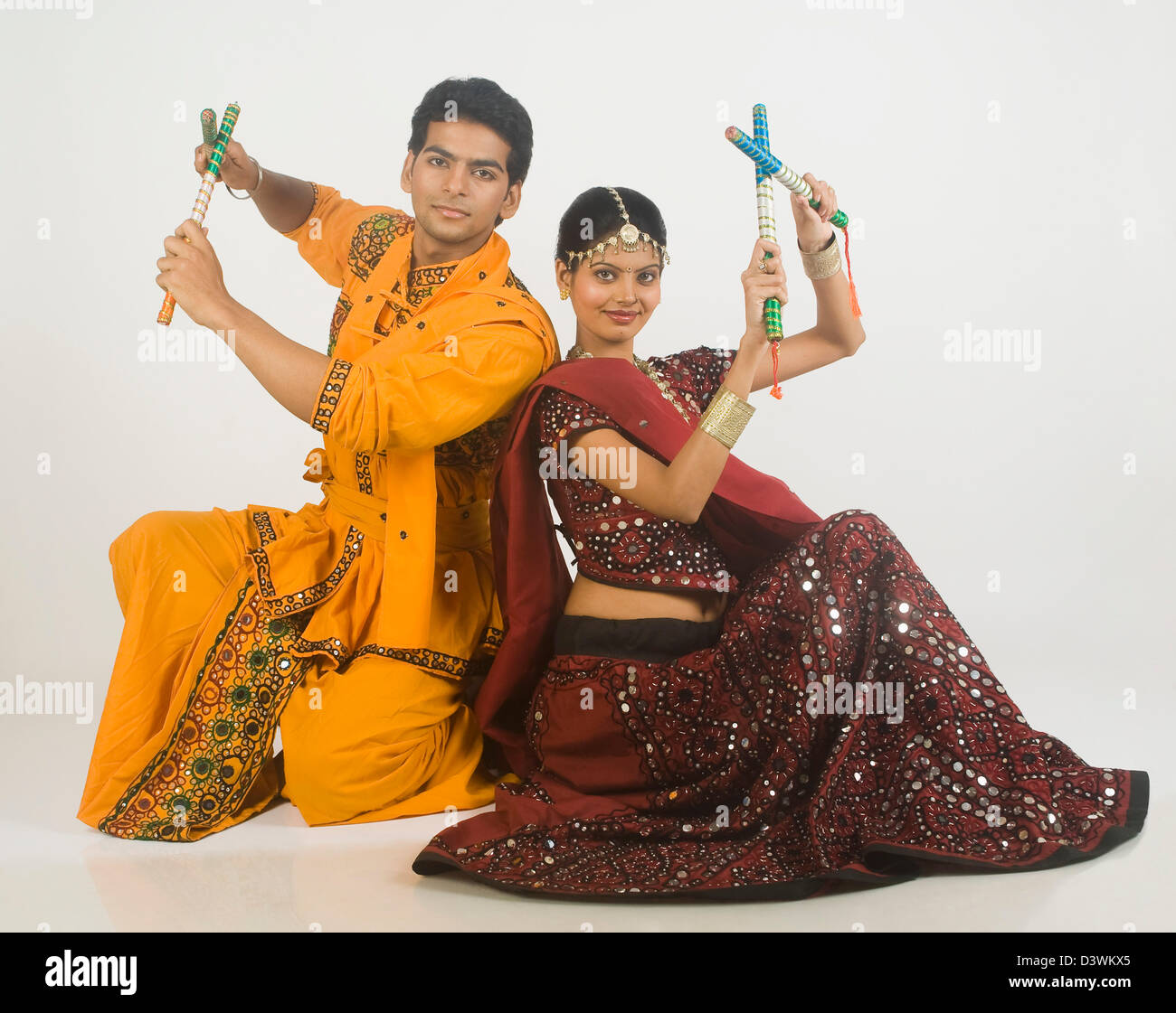 Couple performing dandiya Stock Photo - Alamy