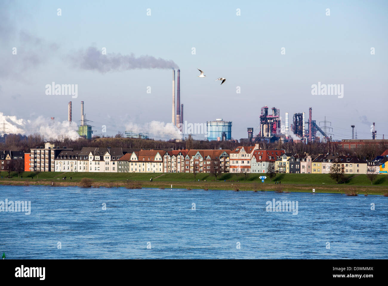 Houses in Duisburg, direct at river Rhine. ThyssenKrupp steelworks
