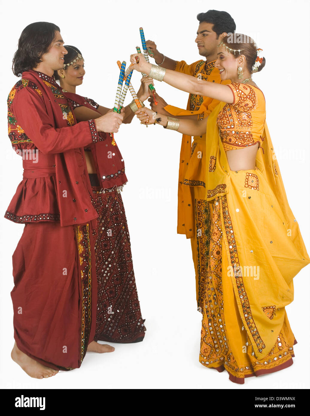 Couples performing dandiya Stock Photo - Alamy