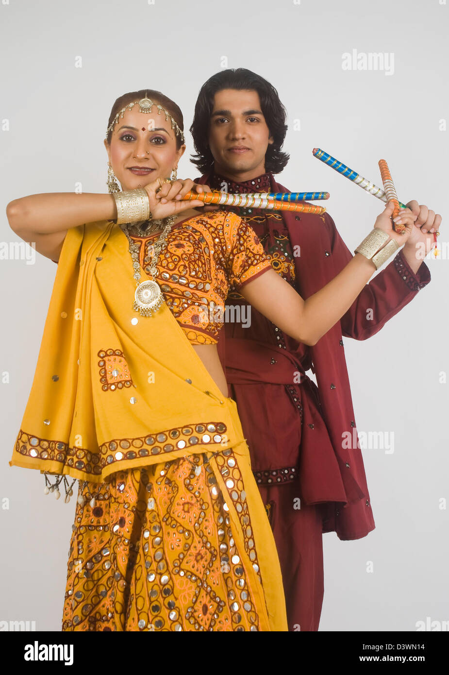 Couple performing dandiya Stock Photo - Alamy