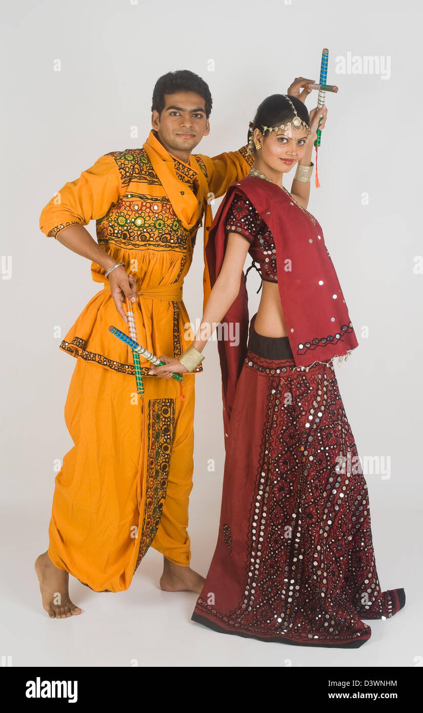 Couple performing dandiya Stock Photo - Alamy