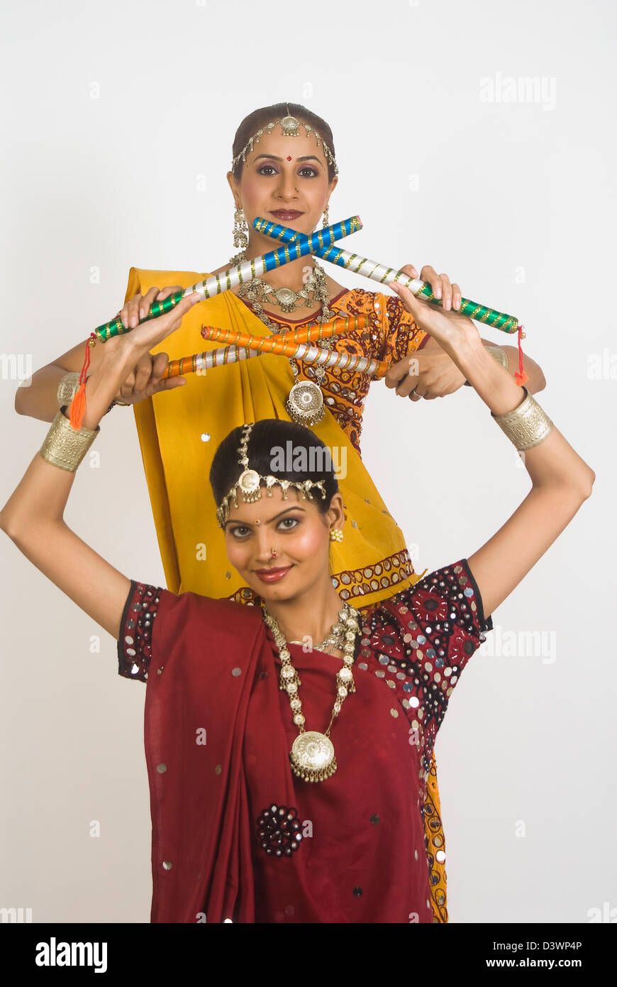 Portrait of two women performing dandiya Stock Photo - Alamy