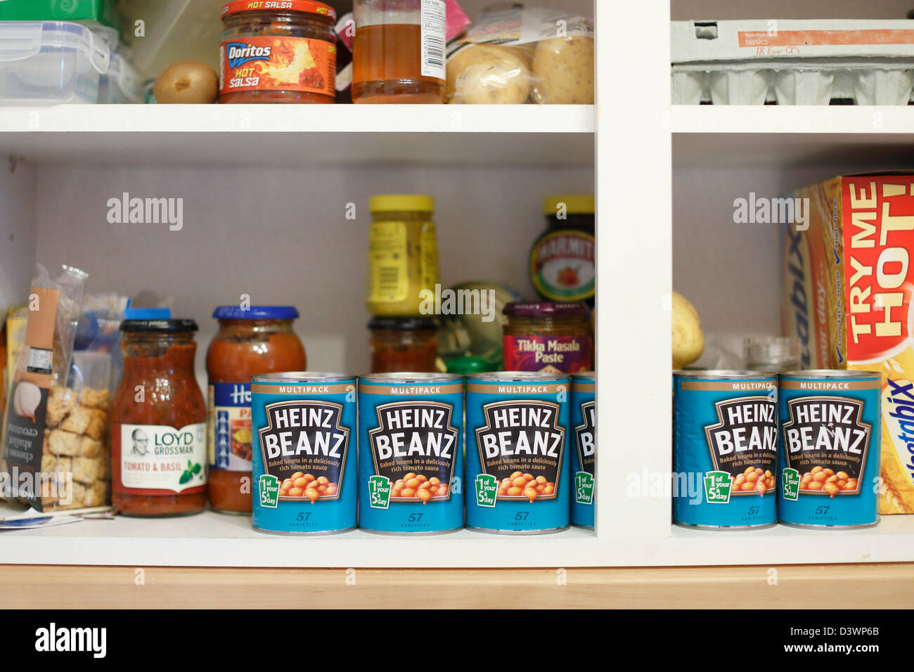 Heinz Baked Beans in a food cupboard. Stock Photo
