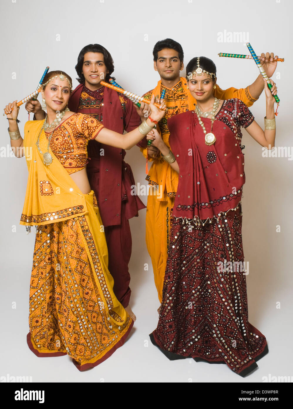 Couples performing dandiya Stock Photo - Alamy