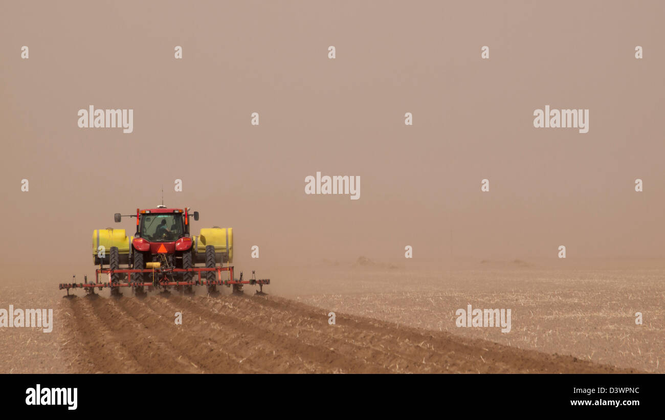 Spring plowing in sand storm near Alamosa, Colorado. Stock Photo