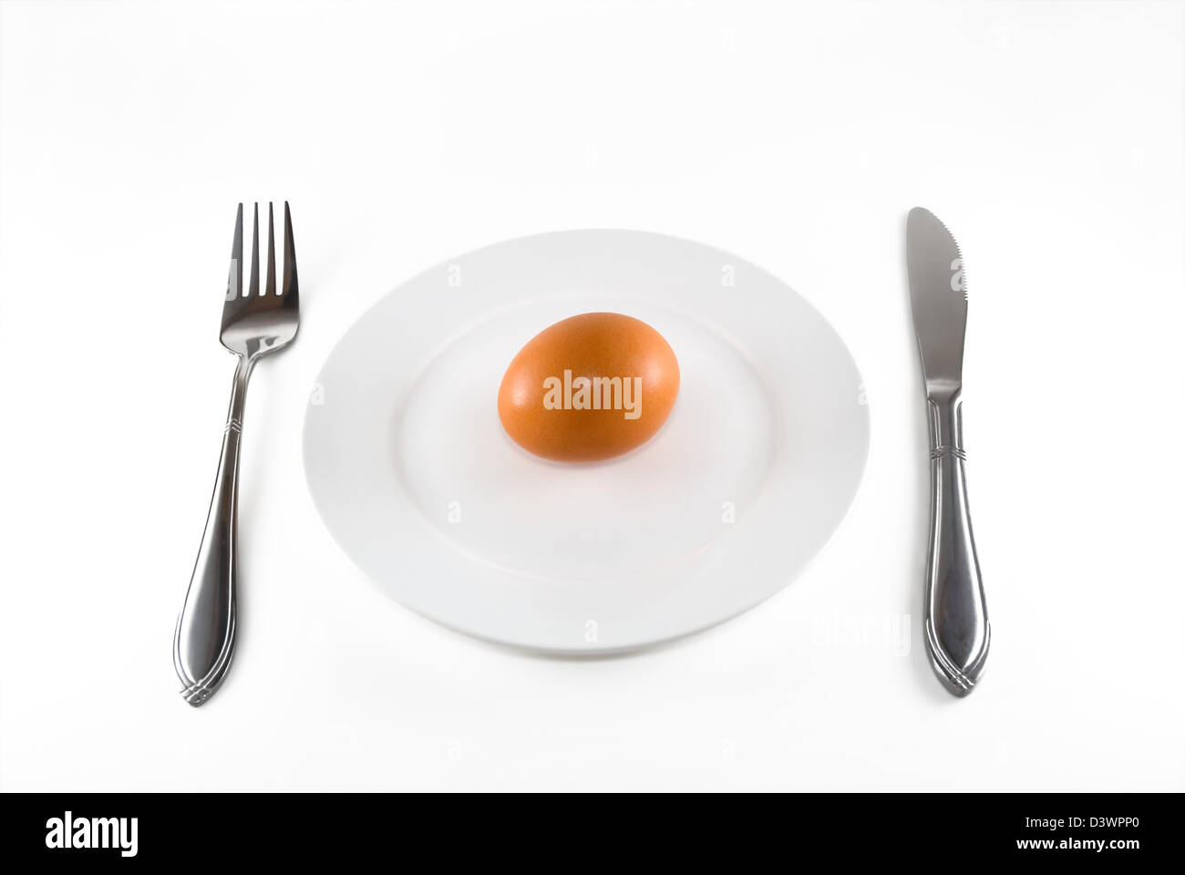 The egg lays on a white plate Stock Photo