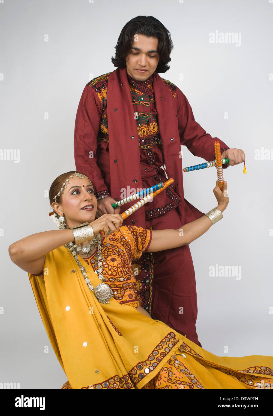 Couple performing dandiya Stock Photo - Alamy