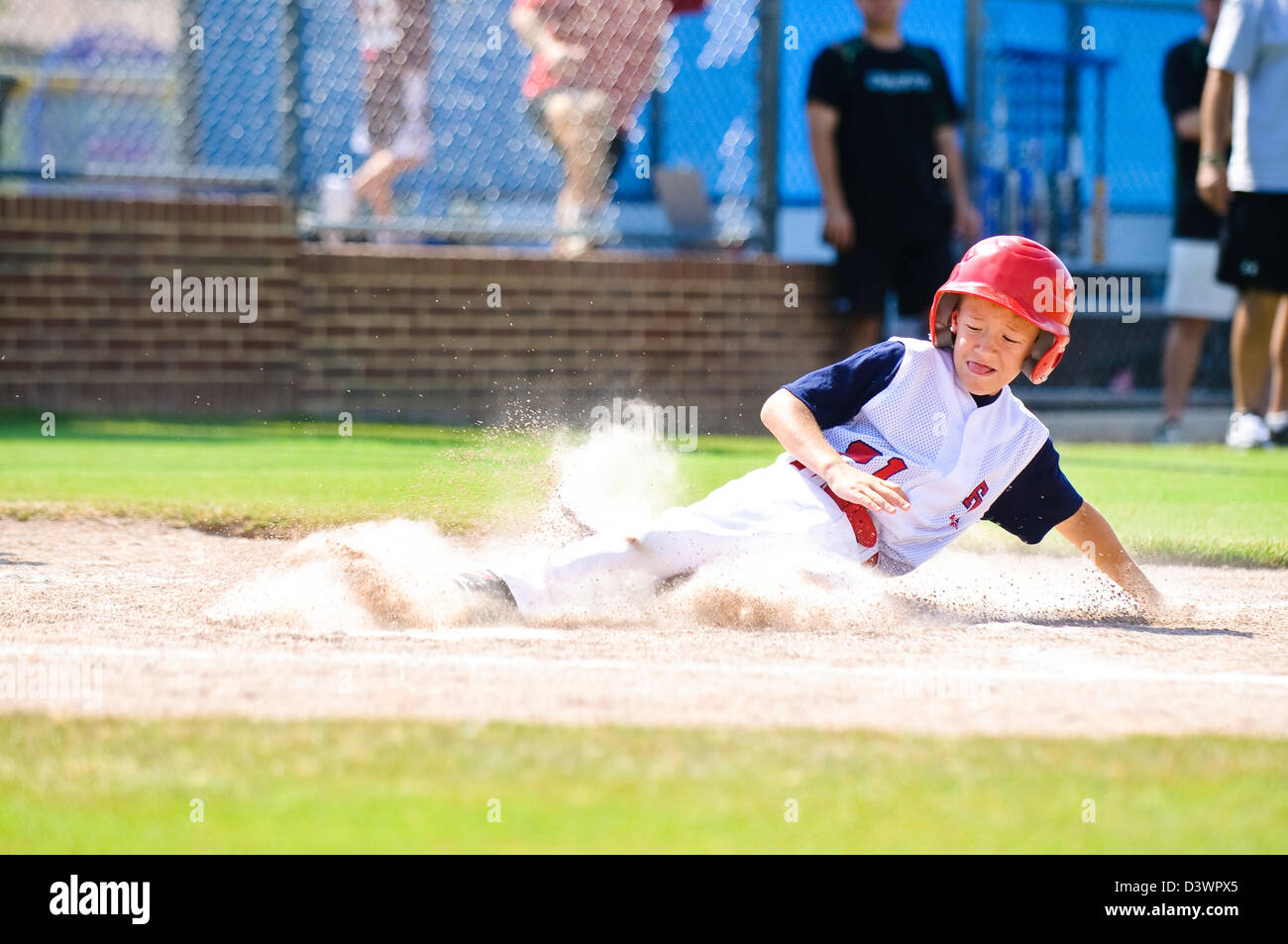 Youth baseball player sliding in at home Stock Photo Alamy