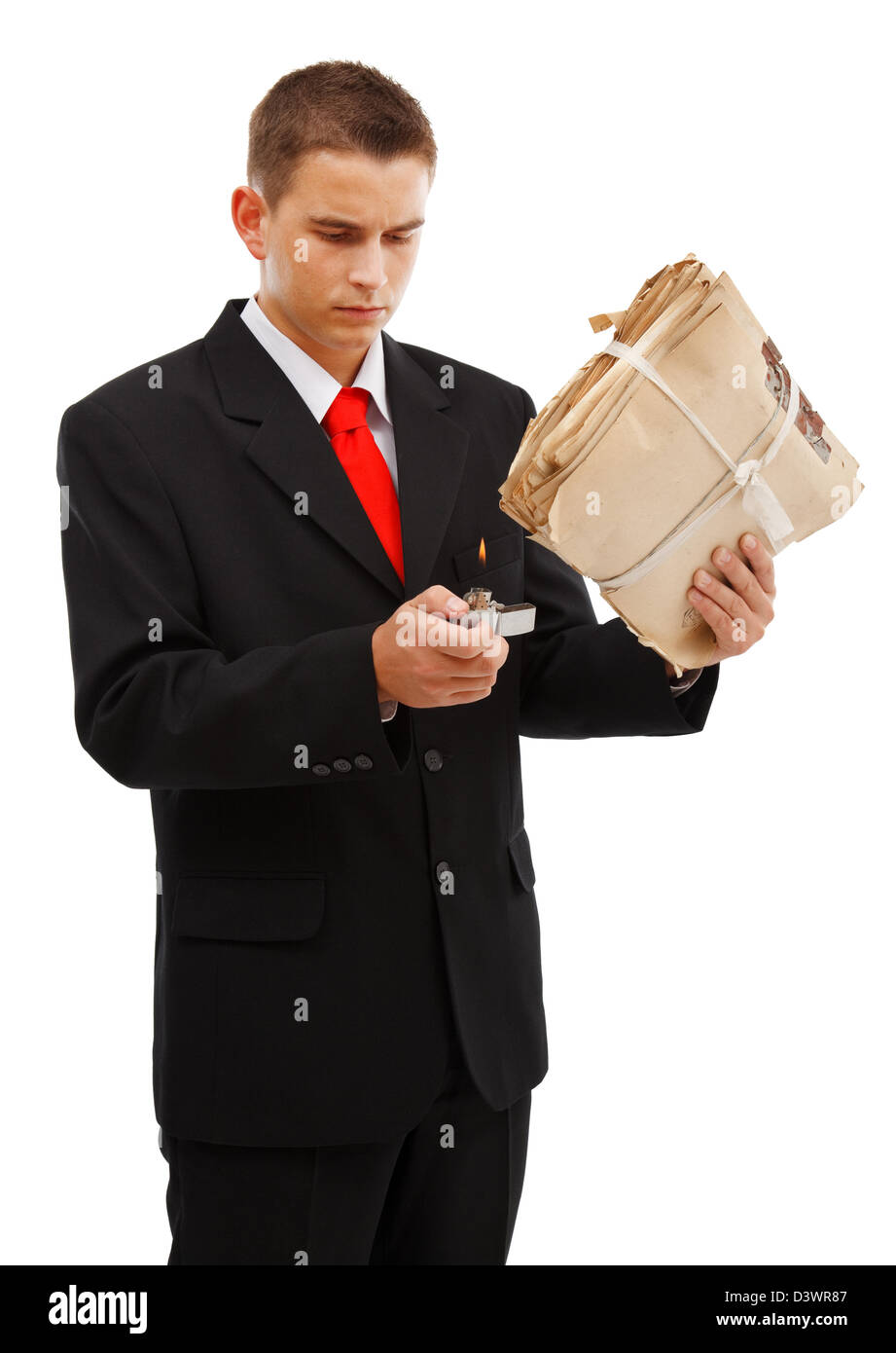 Young business man burning file folder with lighter, to destroy evidence, archive or other documents Stock Photo