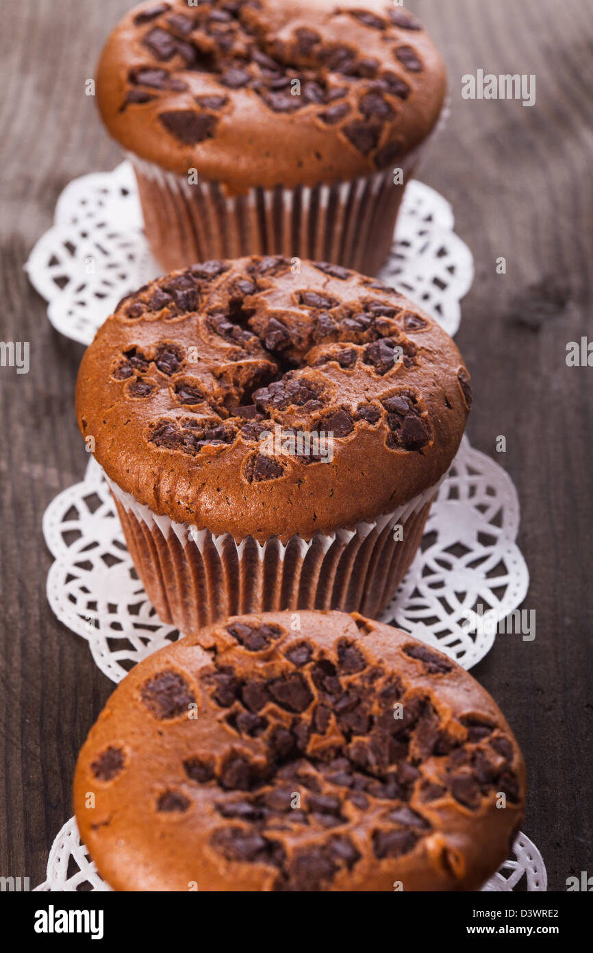 Chocolate muffins with chocolate chips on the wood background closeup ...