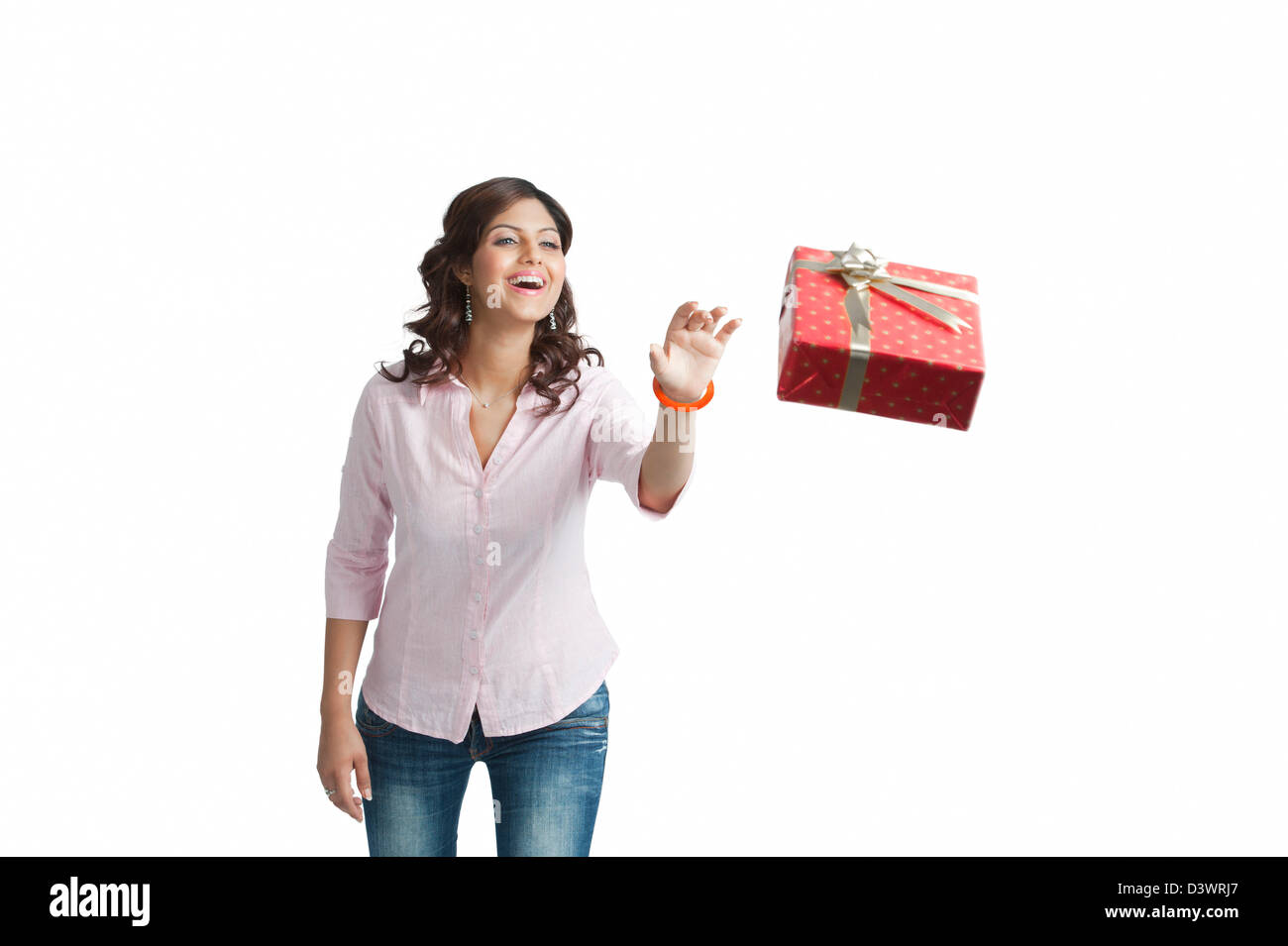 Woman throwing a gift box and smiling Stock Photo Alamy