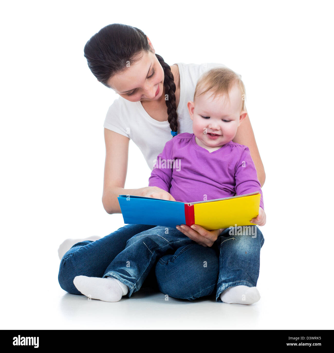 happy mother reading a book to her daughter Stock Photo