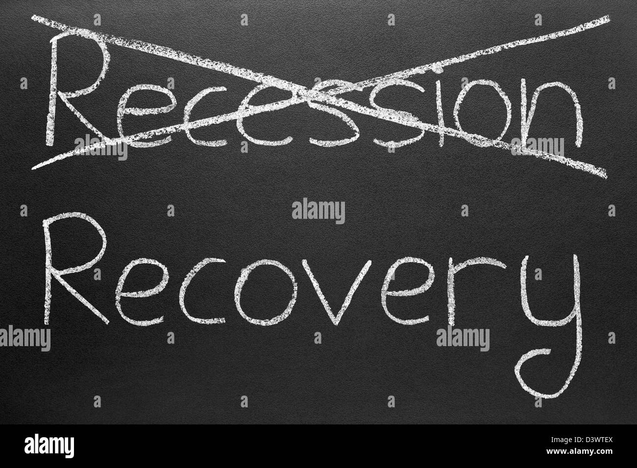 Crossing out recession and writing recovery. Stock Photo