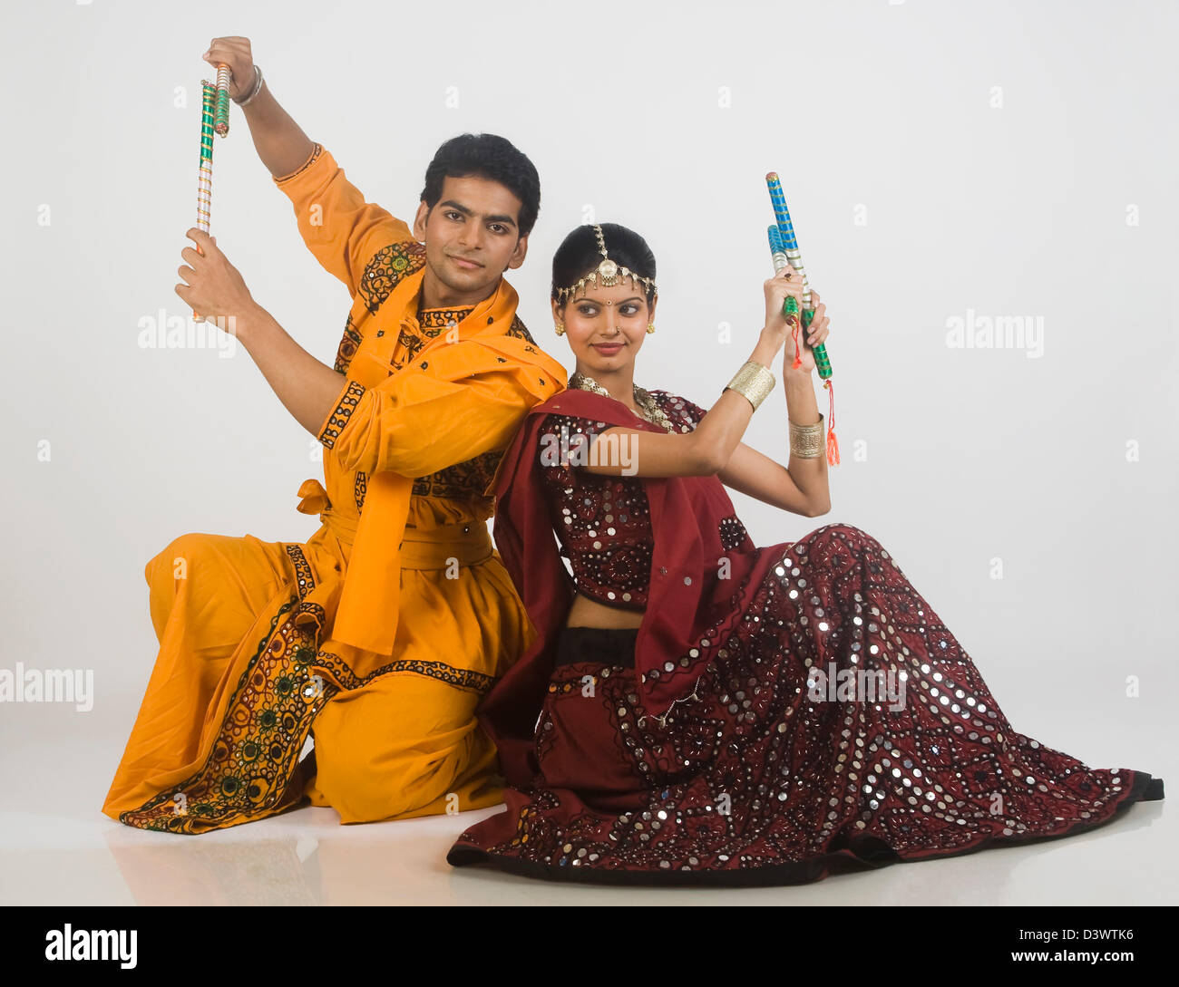 Couple performing dandiya Stock Photo - Alamy