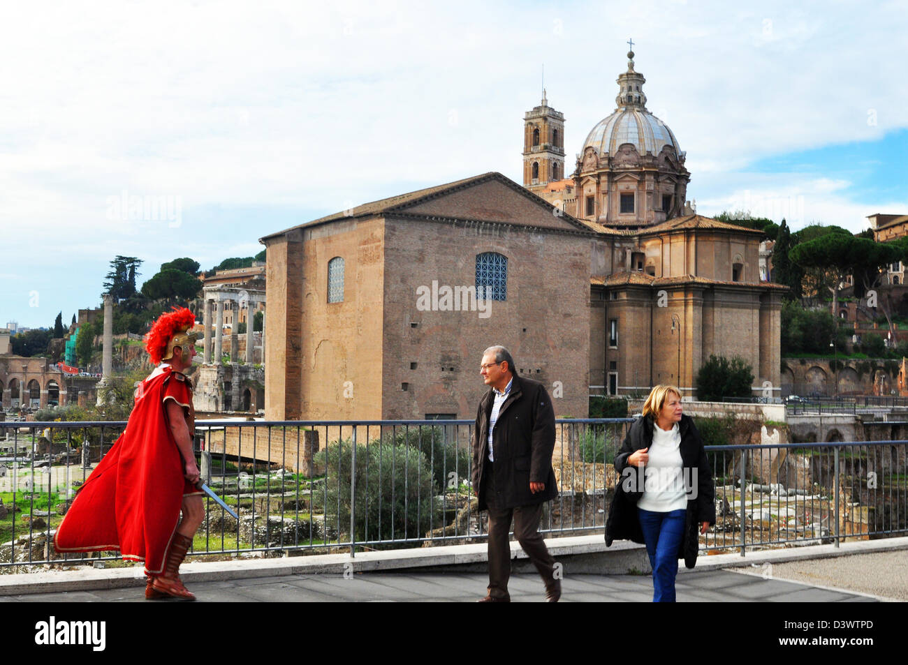 A Roman Soldier tries to attract attention from tourists on the Via del Fori Imperiall Road, Rome, Italy Stock Photo