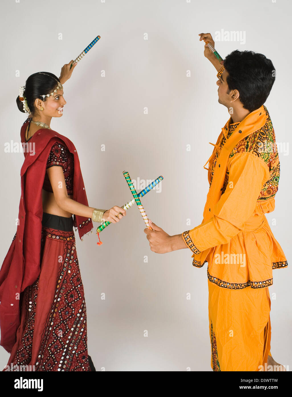 Couple performing dandiya Stock Photo - Alamy