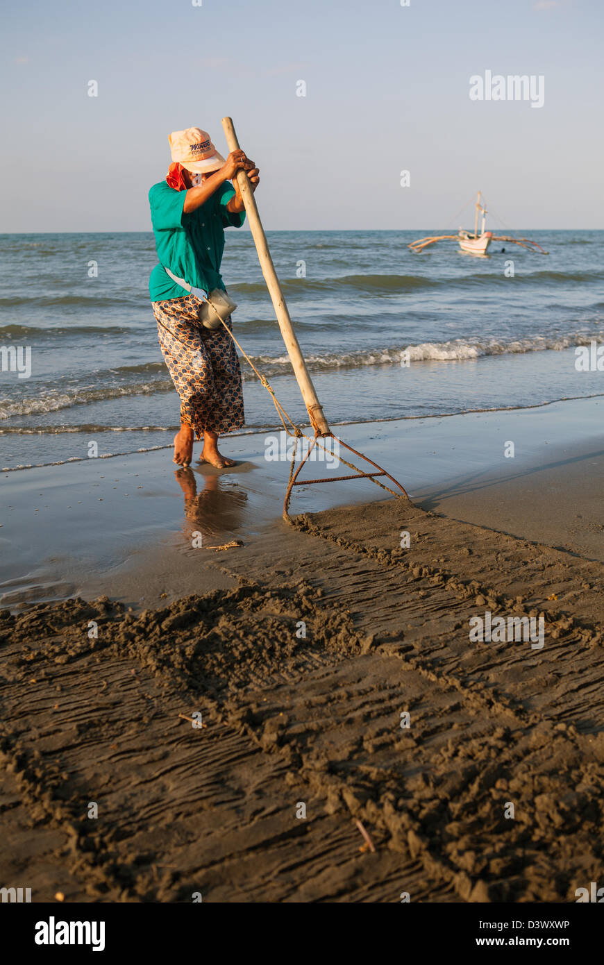 Filipino Woman Collecting Shellfish at Baybay Beach, Panay Island, Philippines. Stock Photo