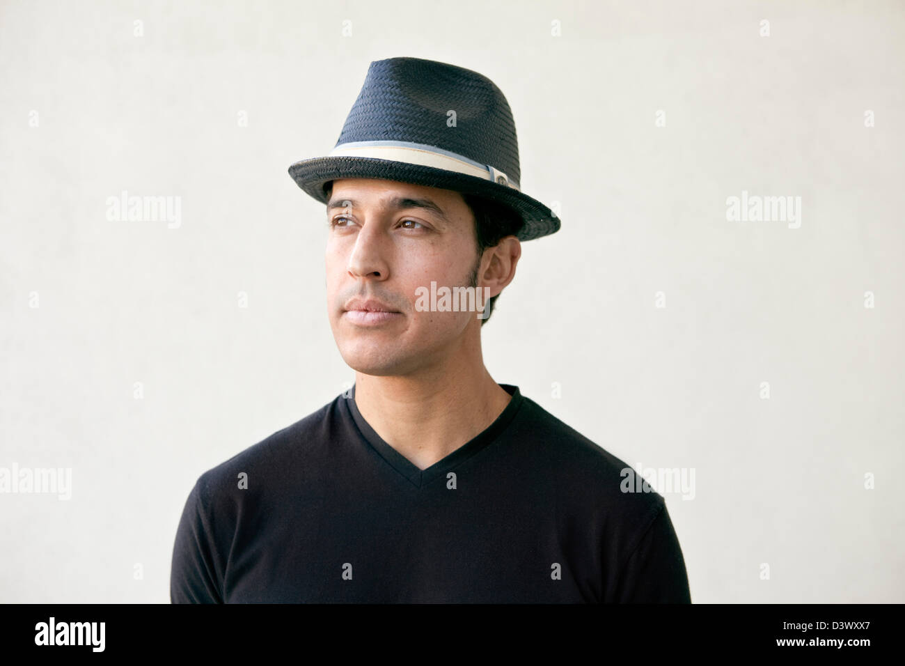Portrait of young adult mexican-american male with a hat Stock Photo