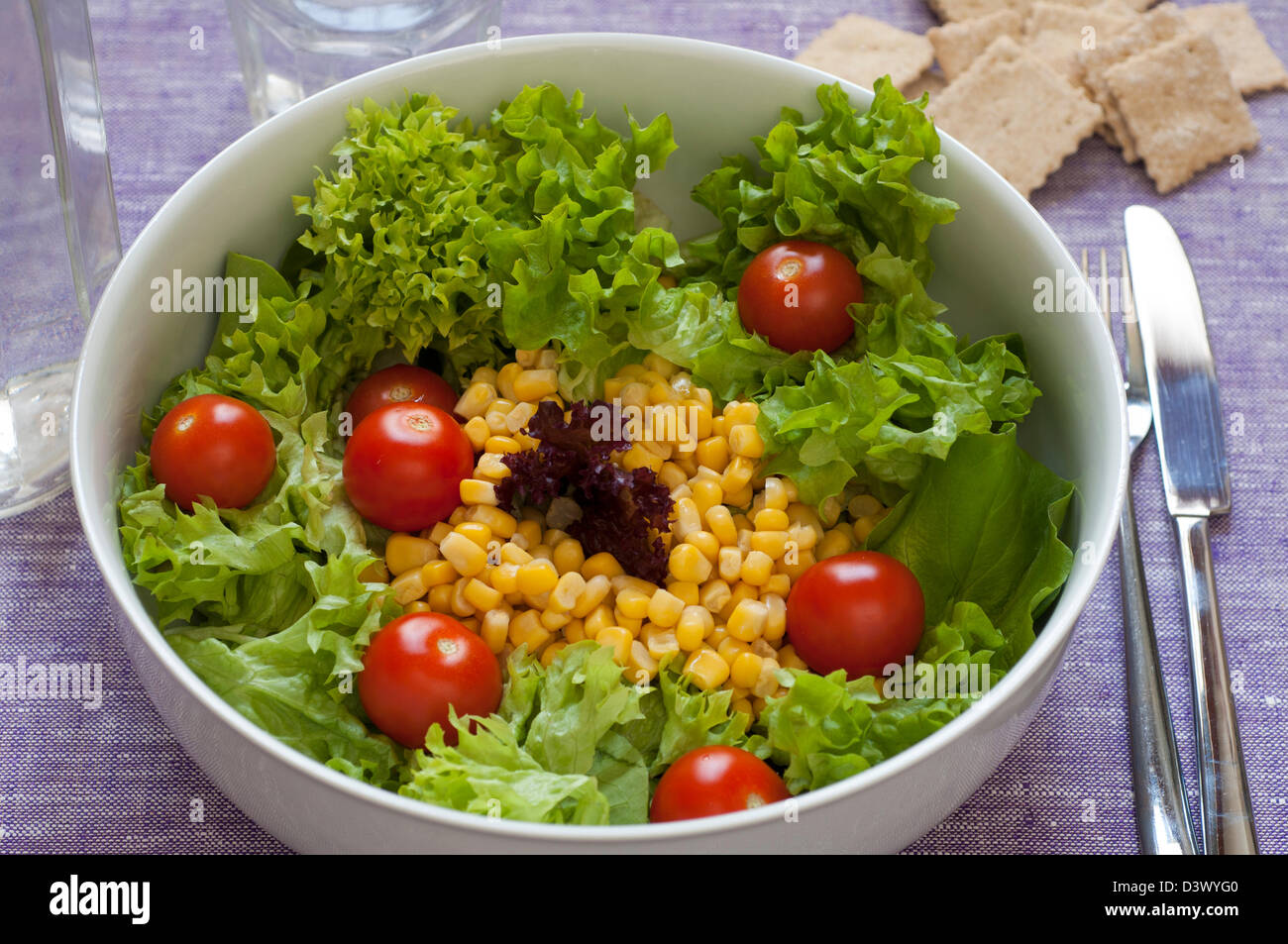 Close-up view of fresh organic mixed salad: lettuce, sweet corn, tomato Stock Photo