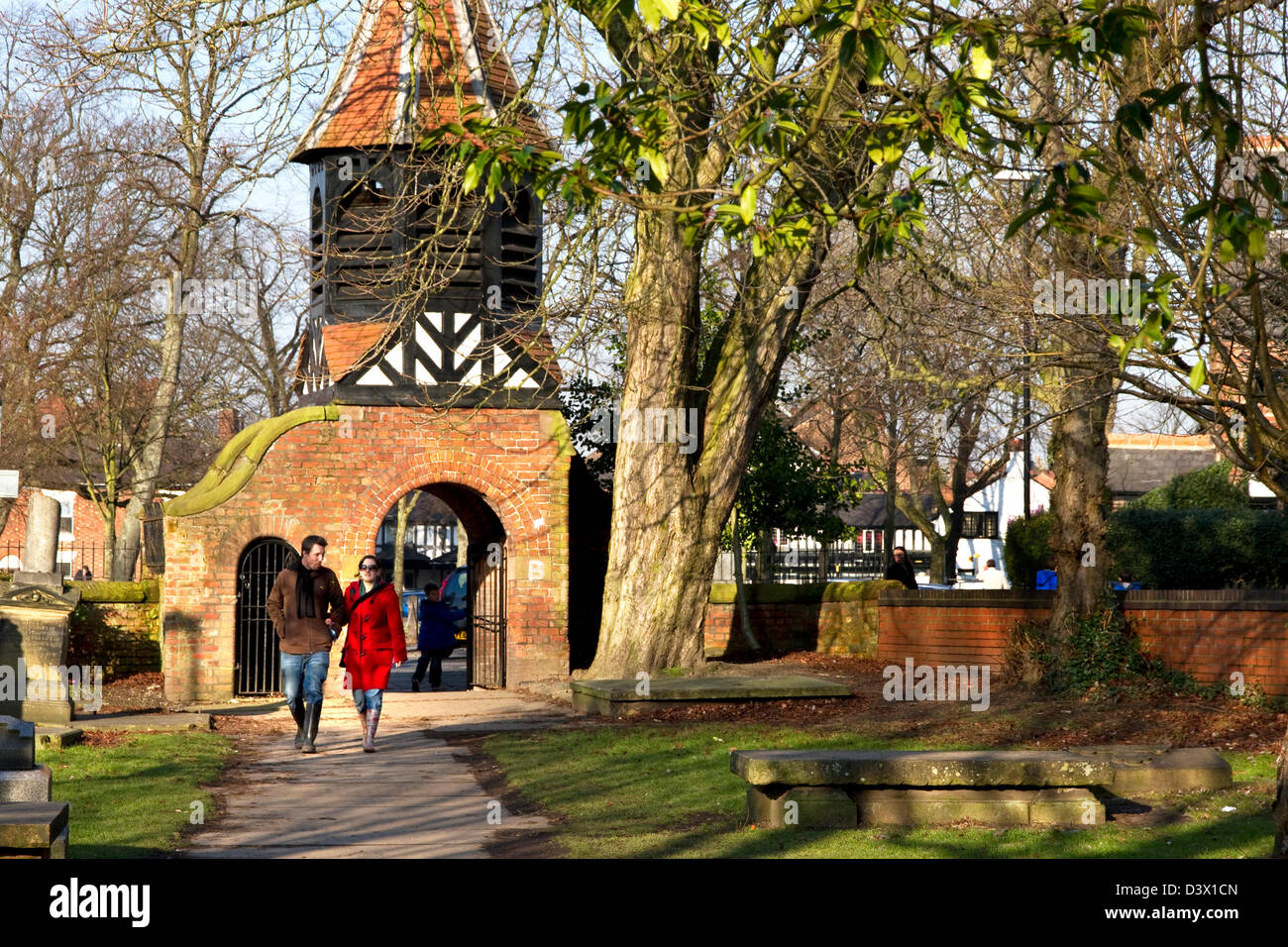 Footpath through former St Clement's churchyard + lych gate with bell