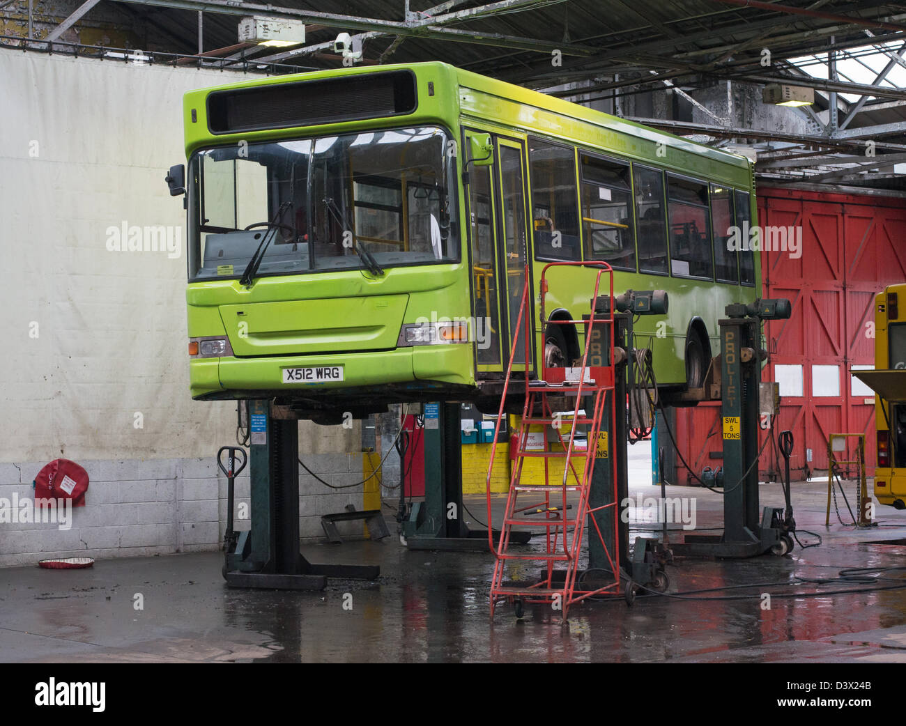 Bus Lifted On Prolift Stands For Maintenance Within The Garage At