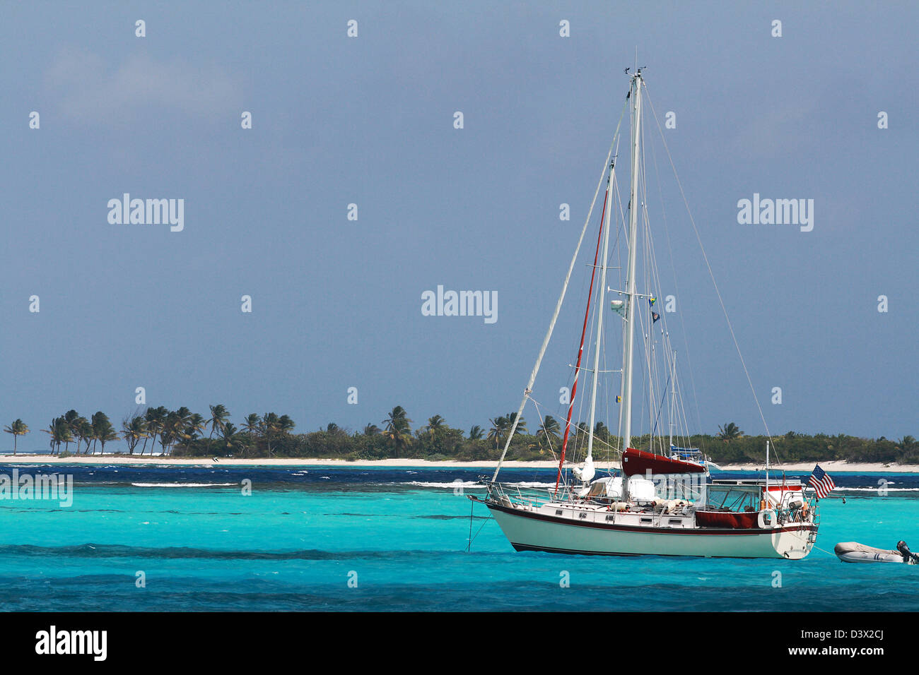 Colorful Grenadines with a White Yacht and Turquoise Caribbean. Stock Photo