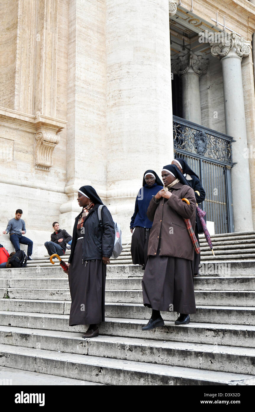 Nuns from all over the world, walk down the steps at St Peter's Basilica, Vatican City, Rome, Italy Stock Photo
