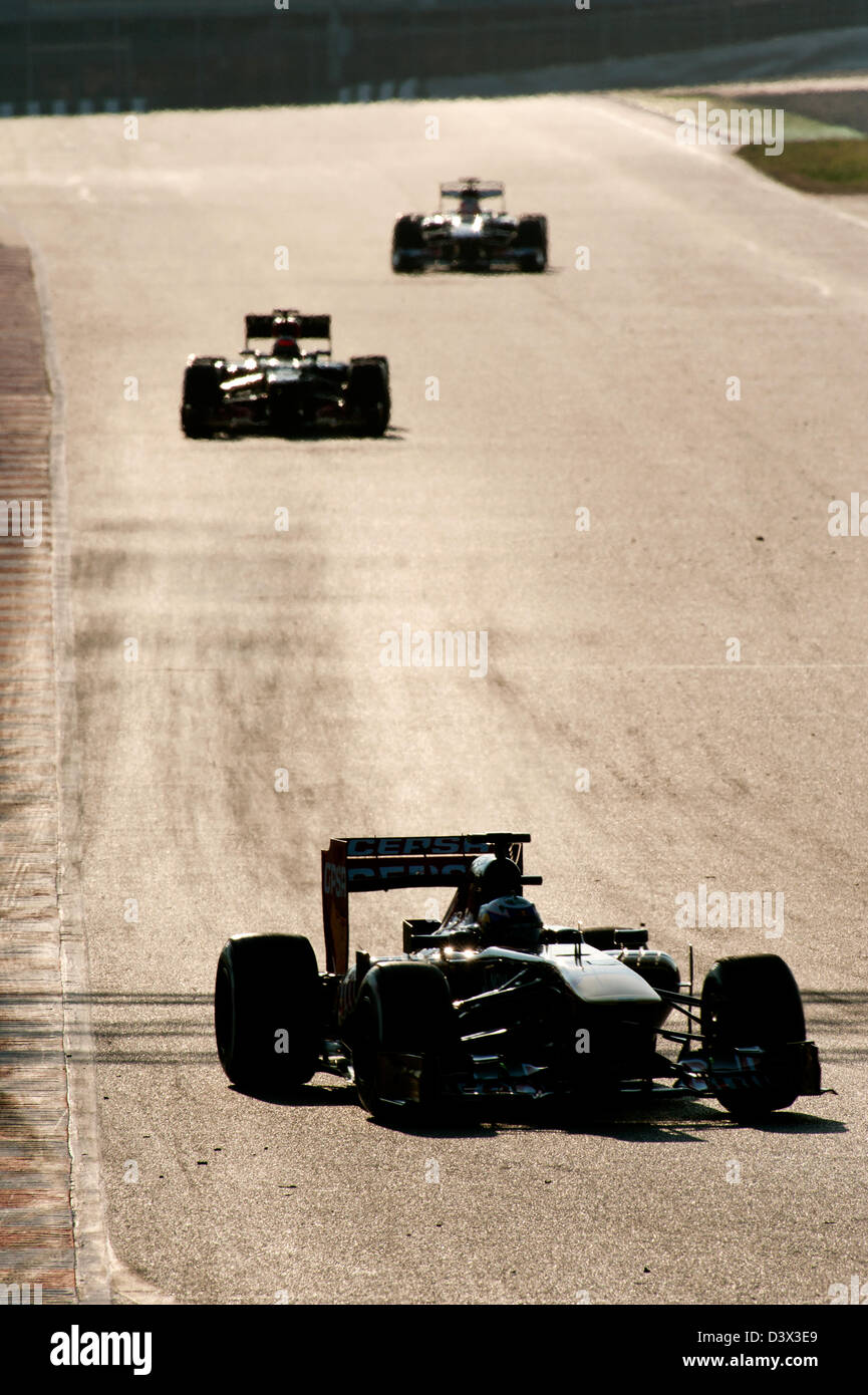 Formula 1 racecars  by sundown during testing sessions on the Circuit de Catalunya near Barcelona, Feb. 2013 Stock Photo