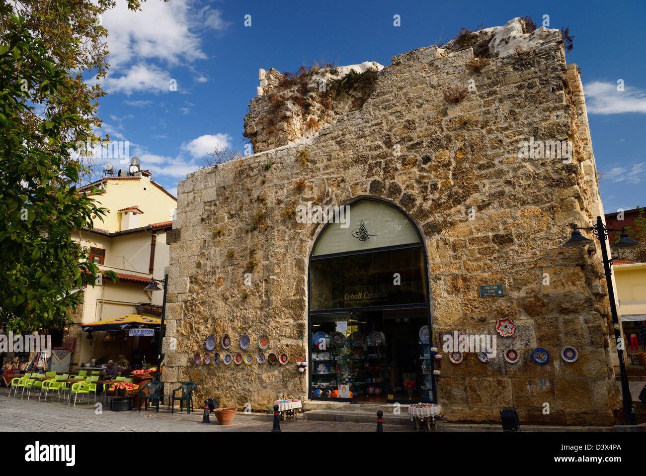 Antalya street with shops and ancient stone building used as a china store in Turkey Stock Photo