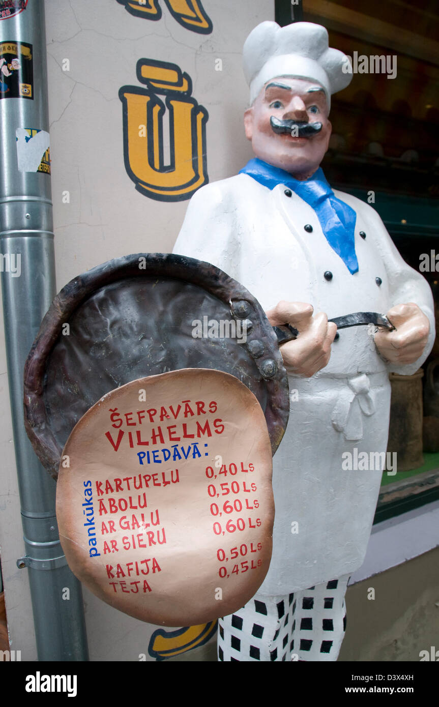 A model of a chef and his frying pan, displaying a menu outside a eatery in Riga Old Town,Riga,Latvia, Baltic States Stock Photo