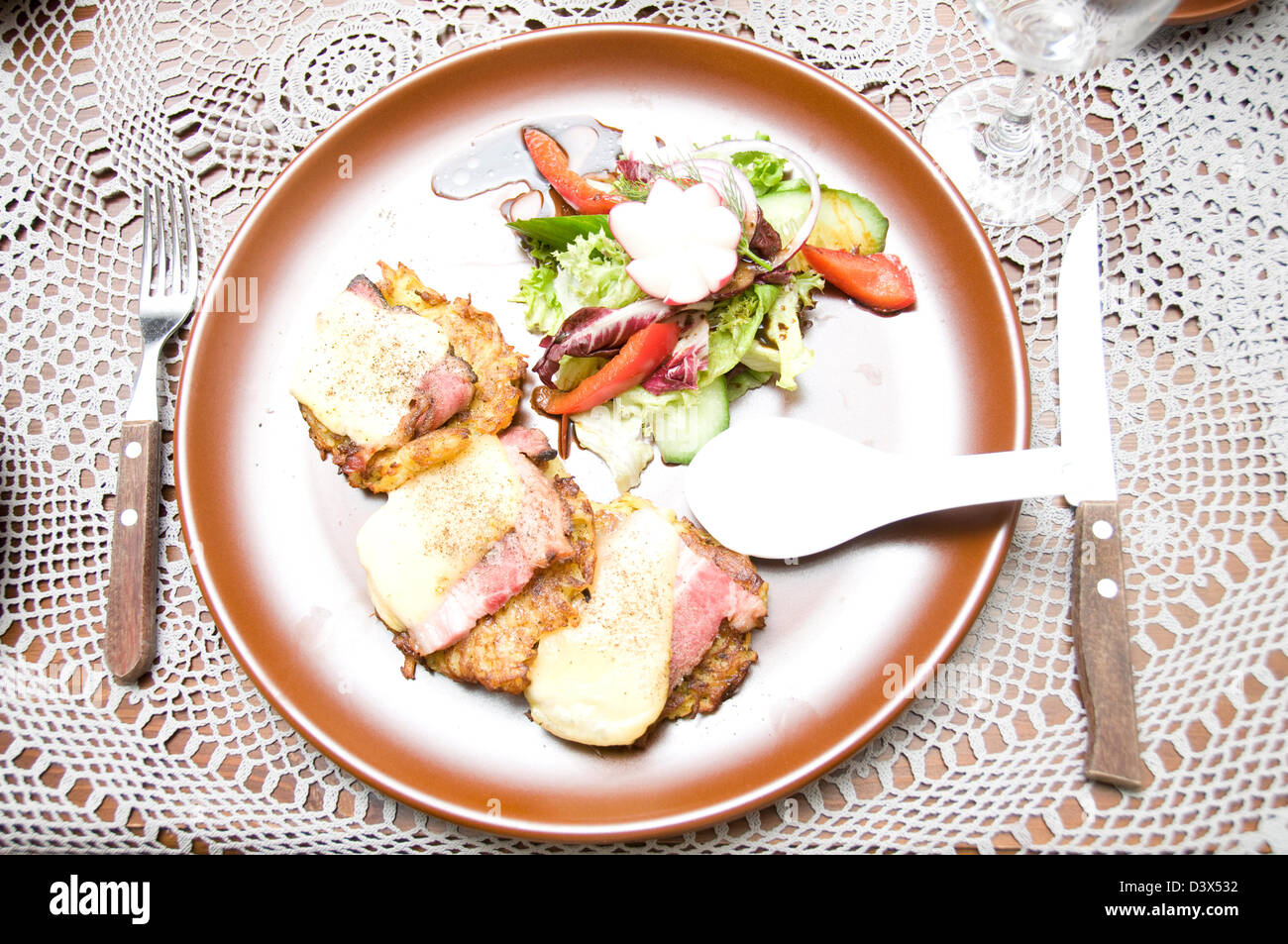 A Latvian lunch of breaded chicken, bacon and Latvian cheese with a ...
