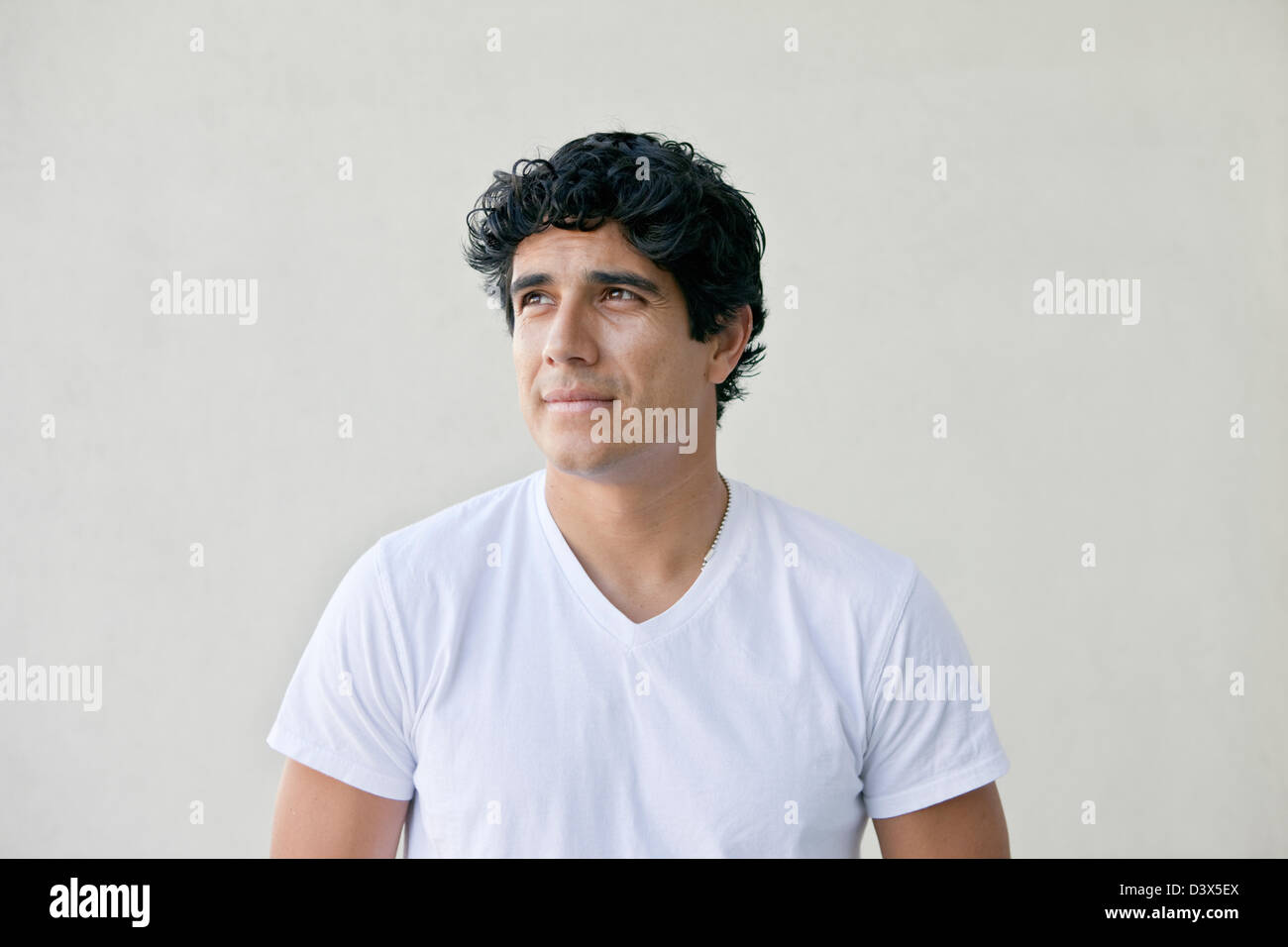 Thinking Portrait of Young Adult Mexican-American Man Stock Photo